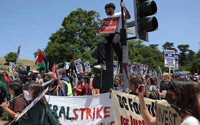 Illustrative: UC Santa Cruz workers who are union members of UAW 4811 and pro-Palestinian protesters carry signs as they demonstrate in front of the UC Santa Cruz campus on May 20, 2024 in Santa Cruz, California. (Justin Sullivan/Getty Images/AFP) Illustrative: UC Santa Cruz workers who are union members of UAW 4811 and pro-Palestinian protesters carry signs as they demonstrate in front of the UC Santa Cruz campus on May 20, 2024 in Santa Cruz, California. (Justin Sullivan/Getty Images/AFP)