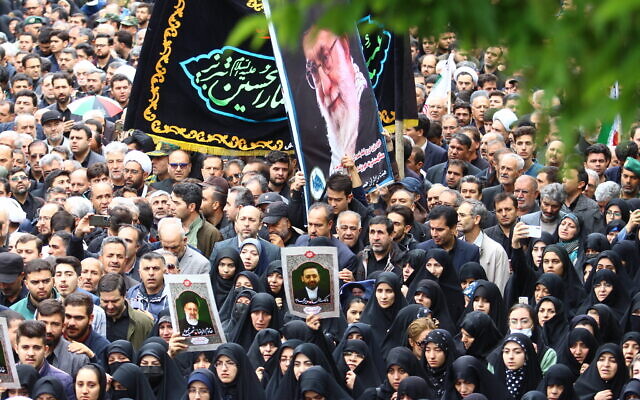 Mourners carrying a portrait of Iran's Supreme leader Ayatollah Ali Khamenei walk in a funeral procession for the late Iranian president Ebrahim Raisi and seven members of his entourage in the northwestern city of Tabriz on May 21, 2024 (ATA DADASHI / MOJ News Agency / AFP) Mourners carrying a portrait of Iran's Supreme leader Ayatollah Ali Khamenei walk in a funeral procession for the late Iranian president Ebrahim Raisi and seven members of his entourage in the northwestern city of Tabriz on May 21, 2024 (ATA DADASHI / MOJ News Agency / AFP)