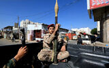 A fighter holds a rocket propelled grenade launcher as forces loyal to the Houthi rebels in Yemen participate in a military parade on the occasion of the 34th National Day to commemorate Yemeni unity, in Sanaa, on May 22, 2024. (MOHAMMED HUWAIS / AFP)