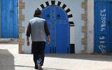 A Tunisian Jewish man walks in Hara Kebira, the main Jewish quarter in the resort island of Djerba, during the annual Jewish pilgrimage, on May 24, 2024. (Fethi Belaid / AFP)