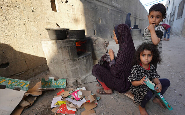 A displaced Palestinian cooks on a wood burning stove in Deir al-Balah in the central Gaza Strip, on May 24, 2024. (Bashar Taleb/AFP) A displaced Palestinian cooks on a wood burning stove in Deir al-Balah in the central Gaza Strip, on May 24, 2024. (Bashar Taleb/AFP)