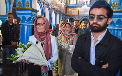 French Ambassador to Tunisia Anne Gueguen (Centre-L) and US Deputy Chief of Mission Natasha Franceschi (C) carry flowers in memory of those killed in a mass shooting last year at the Ghriba synagogue in the resort island of Djerba on May 26, 2024. (Fethi Belaid / AFP)