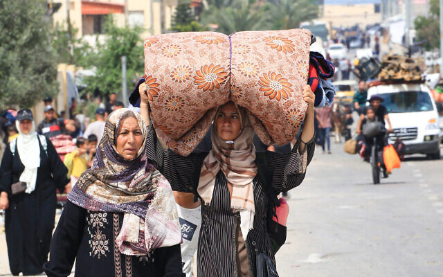 Palestinians flee the area of Tal al-Sultan in Rafah with their belongings on May 28, 2024. (Eyad Baba/AFP) Palestinians flee the area of Tal al-Sultan in Rafah with their belongings on May 28, 2024. (Eyad Baba/AFP)