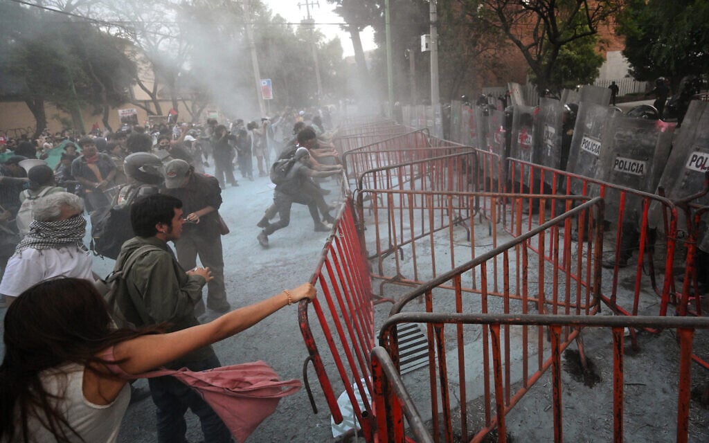 Rioters clash with police during a pro-Palestinian, anti-Israel rally called "Urgent action for Rafah," held in front of the Israeli embassy in Mexico City on May 28, 2024. (Photo by Pedro PARDO / AFP)