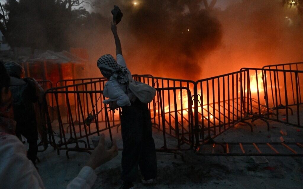 A rioter takes part in a pro-Palestinian, anti-Israel rally called "Urgent action for Rafah," held in front of the Israeli embassy in Mexico City on May 28, 2024. (Photo by Pedro Pardo / AFP)