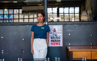 Rachel Goldberg, whose son Hersh Goldberg-Polin has been held hostage by Hamas since October 7, poses for a photo next to a poster of her son during an interview in Jerusalem on May 29, 2024. The number 236 that Rachel Goldberg-Polin taped above her heart marks the number of days her son Hersh had been held hostage in Gaza when she met AFP at her Jerusalem office. (Photo by Ahikam Seri/AFP)