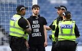 A demonstrator wearing a t-shirt reading 'Red card for Israel' chained himself to the goal post prior to the UEFA Women's Euro 2025 League B Group 2 qualifying soccer match between Scotland and Israel at Hampden Park stadium in Glasgow, Scotland, on May 31, 2024. (ANDY BUCHANAN / AFP)