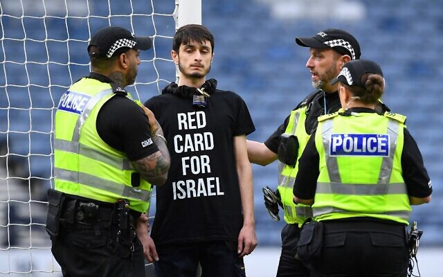 A demonstrator wearing a t-shirt reading 'Red card for Israel' chained himself to the goal post prior to the UEFA Women's Euro 2025 League B Group 2 qualifying soccer match between Scotland and Israel at Hampden Park stadium in Glasgow, Scotland, on May 31, 2024. (ANDY BUCHANAN / AFP)