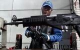 A worker assembles a Galil-GT assault rifle at the Colombian based military weapons manufacturer, Indumil, in Soacha, Colombia. (AP Photo/Fernando Vergara)