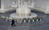 King Willem-Alexander and Queen Maxima walked past wreaths at the national monument during the Remembrance Day ceremony on Dam Square in Amsterdam, Netherlands, May 4, 2022, commemorating civilians and members of the armed forces who have died in wars and peacekeeping missions since the start of the Second World War. (Koen van Weel/Pool Photo via AP)