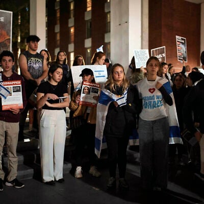 Jewish Rutgers University students and members of the community gather holding placards and flags to hold solidarity and vigil for Israel on October 25, 2023, in New Brunswick, New Jersey. (AP Photo/Andres Kudacki)