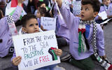 Illustrative: A Palestinian elementary student holds a placard reading 'From the river to the sea, Palestine will be free' in Beirut, Lebanon, December 14, 2023. (AP Photo/Hussein Malla)