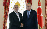 Turkish President Recep Tayyip Erdogan, right, and Hamas political leader Ismail Haniyeh, shake hands during their meeting in Istanbul, Turkey, April 20, 2024. (Turkish Presidency via AP)