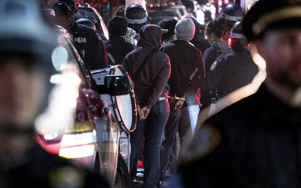 New York City police officers take people into custody near the Columbia University campus in New York, April 30, 2024, after a building taken over by anti-Israel activists earlier in the day was cleared, along with a tent encampment. (AP Photo/Craig Ruttle)