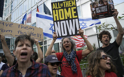 Families and supporters of Israeli hostages held by Hamas in Gaza hold banners and flags during a protest calling for their return, outside a meeting between US Secretary of State Antony Blinken and families of hostages in Tel Aviv, May 1, 2024. (AP Photo/Oded Balilty)