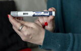 Illustrative: Woman holds up a dosage of Wegovy, a drug used for weight loss, in Front Royal, Virginia, March 1, 2024. (AP Photo/Amanda Andrade-Rhoades)