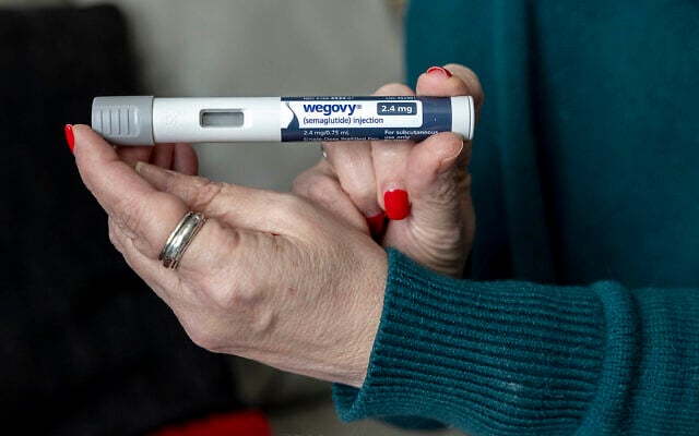 Illustrative: Woman holds up a dosage of Wegovy, a drug used for weight loss, in Front Royal, Virginia, March 1, 2024. (AP Photo/Amanda Andrade-Rhoades) Illustrative: Woman holds up a dosage of Wegovy, a drug used for weight loss, in Front Royal, Virginia, March 1, 2024. (AP Photo/Amanda Andrade-Rhoades)