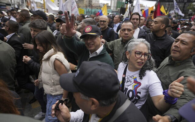 Colombian President Gustavo Petro greets supporters as he attends the International Workers' Day march in Bogota, Colombia, Wednesday, May 1, 2024. (AP Photo/Fernando Vergara)