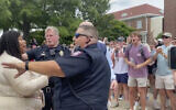In this photo taken from video provided by Stacey J. Spiehler, a pro-Palestinian protester is confronted by hecklers at the University of Mississippi, May 2, 2024, in Oxford, Mississippi. (Stacey J. Spiehler via AP)