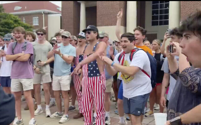 In this photo taken from video provided by Stacey J. Spiehler, hecklers shout at a pro-Palestinian protester at the University of Mississippi, May 2, 2024, in Oxford, Mississippi. (Stacey J. Spiehler via AP)