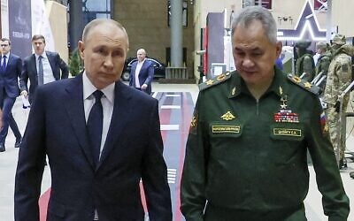 Russian President Vladimir Putin, left, and then Russian Defense Minister Sergei Shoigu arrive for a meeting with the military brass in Moscow, Russia, December 19, 2023. (Mikhail Klimentyev, Sputnik, Kremlin Pool Photo via AP, File)