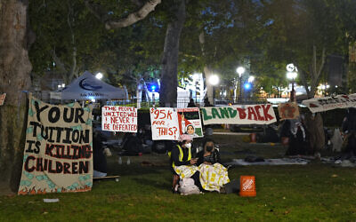 People stand guard outside an encampment set up by pro-Palestinian and anti-Israel demonstrators on the campus at the University of Southern California, May 4, 2024, in Los Angeles. (AP Photo/Ryan Sun)