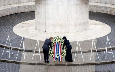 Dutch King Willem-Alexander and Queen Maxima lay a wreath during a solemn annual national service to commemorate the dead in World War II in Amsterdam, Netherlands, May 4, 2024. (Remko de Waal/ANP/Pool Photo via AP)