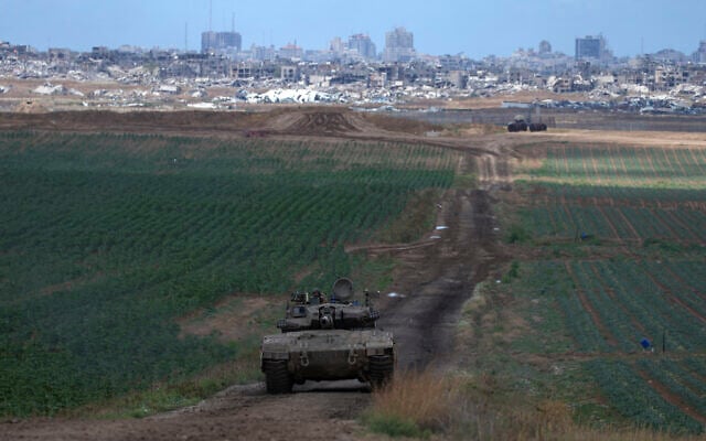 An Israeli Defense Forces tank drives away from the Gaza Strip, as seen from southern Israel, May 6, 2024. (AP Photo/ Tsafrir Abayov) An Israeli Defense Forces tank drives away from the Gaza Strip, as seen from southern Israel, May 6, 2024. (AP Photo/ Tsafrir Abayov)