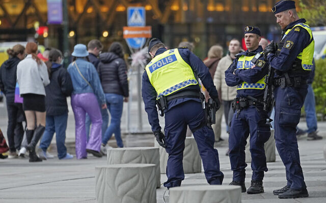 Police stand guard as people queue in line for the second dress rehearsal for the first semifinal at the Eurovision Song Contest in Malmo, Sweden, Monday, May 6, 2024. (AP Photo/Martin Meissner)