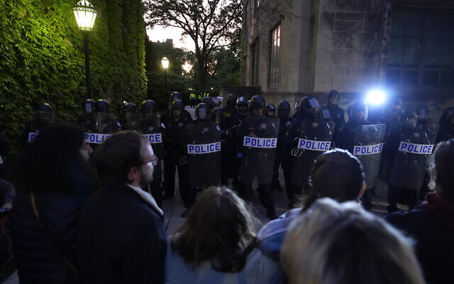 Police block pro-Palestinian protesters from returning to their encampment as the encampment is dismantled at the University of Chicago, Tuesday, May 7, 2024. (AP Photo/Charles Rex Arbogast)