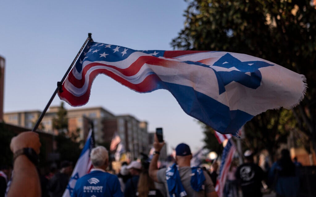 A pro-Israel supporter waves a flag while marching outside the University of Southern California campus in Los Angeles, May 8, 2024. (AP Photo/Jae C. Hong)