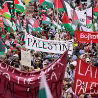 People carry banners and Palestinian flags during an anti-Israel demonstration against Israel's participation in Eurovision ahead of the second semifinal at the Eurovision Song Contest in Malmo, Sweden, Thursday, May 9, 2024. (AP Photo/Martin Meissner)