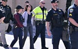 Police detain a pro-Palestinian demonstrator who attempted to block traffic from the garage of the Stata Center at MIT, as part of a protest against Israel, May 9, 2024, in Cambridge, Massachusetts. (AP Photo/Josh Reynolds)