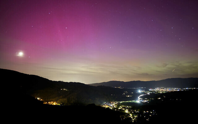 Northern lights appear over the Dreisamtal valley in the Black Forest near Freiburg, Germany, May 10, 2024. (Valentin Gensch/dpa via AP)