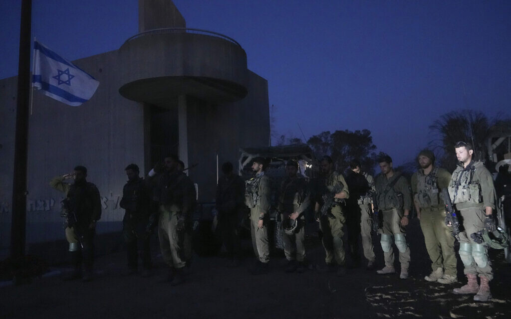 Soldiers stand still as a siren marks the beginning of Israel's Memorial Day for fallen soldiers who died in the nation's conflicts and victims of terror attacks, near the border with the Gaza Strip, May 12, 2024. (AP Photo/Tsafrir Abayov)