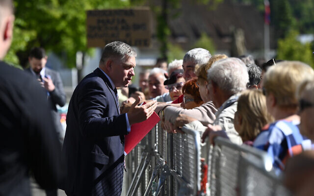 Slovakia's Prime Minister Robert Fico, center, speaks with people before the cabinet's away-from-home session in the town of Handlova, Slovakia, May 15, 2024. (Radovan Stoklasa/TASR via AP) Slovakia's Prime Minister Robert Fico, center, speaks with people before the cabinet's away-from-home session in the town of Handlova, Slovakia, May 15, 2024. (Radovan Stoklasa/TASR via AP)