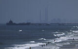 A ship is seen off the coast of Gaza near a US-built floating pier that will be used to facilitate aid deliveries, as seen from the central Gaza Strip, Thursday, May 16, 2024. (AP/Abdel Kareem Hana)