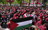 A student holds up the Palestinian flag as the 13 students, who have been barred from graduating due to protest activities, are recognized by a student address speaker during the commencement in Harvard Yard at Harvard University, May 23, 2024, in Cambridge, Massachusetts. (AP Photo/Charles Krupa)
