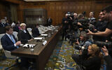 Journalists at the International Court of Justice photograph the Israeli legal team before Judges enter, in The Hague, Netherlands, May 24, 2024. (AP Photo/Peter Dejong)