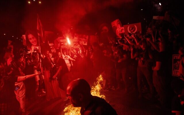 Demonstrators set a fire during a protest against Prime Minister Benjamin Netanyahu's government, and calling for the release of hostages held in the Gaza Strip by the Hamas terror group, in Tel Aviv, May 26, 2024. (AP Photo/Ariel Schalit) Demonstrators set a fire during a protest against Prime Minister Benjamin Netanyahu's government, and calling for the release of hostages held in the Gaza Strip by the Hamas terror group, in Tel Aviv, May 26, 2024. (AP Photo/Ariel Schalit)