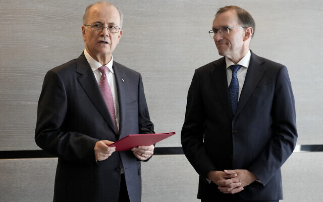 Palestinian Authority Prime Minister Mohammed Mustafa, left, after receiving a document handed over by Norway's Foreign Minister Espen Barth Eide, right, prior to a meeting for talks on the Middle East in Brussels, May 26, 2024.(AP Photo/Virginia Mayo) Palestinian Authority Prime Minister Mohammed Mustafa, left, after receiving a document handed over by Norway's Foreign Minister Espen Barth Eide, right, prior to a meeting for talks on the Middle East in Brussels, May 26, 2024.(AP Photo/Virginia Mayo)