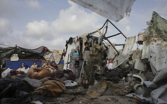 Displaced Palestinians inspect their tents next to an UNRWA facility west of Rafah city, Gaza Strip, May 28, 2024. (AP Photo/Jehad Alshrafi) Displaced Palestinians inspect their tents next to an UNRWA facility west of Rafah city, Gaza Strip, May 28, 2024. (AP Photo/Jehad Alshrafi)