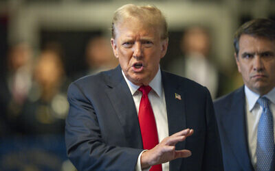 Former US president Donald Trump speaks to the media outside of his trial at Manhattan Criminal Court, in New York, May 28, 2024. (Steven Hirsch/New York Post via AP, Pool)