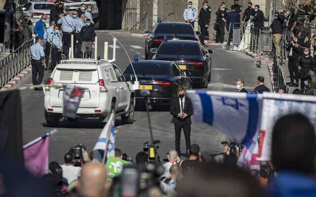 Illustrative: Protesters and security guards outside the Jerusalem District Court as the convoy carrying prime minister Benjamin Netanyahu leaves his trial at the court. (Olivier Fitoussi/Flash90) Illustrative: Protesters and security guards outside the Jerusalem District Court as the convoy carrying prime minister Benjamin Netanyahu leaves his trial at the court. (Olivier Fitoussi/Flash90)