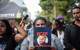 Family members and supporters of Solomon Tekah protest while Haifa Magistrate's Court Judge Zayed Falah and the the policeman accused of fatally shooting Solomon Tekah visit the scene in Kiryat Haim where he was killed, December 15, 2022. (Shir Torem/Flash90)