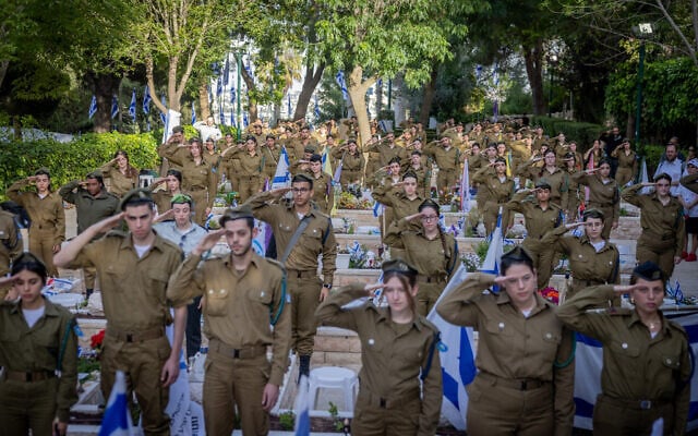 Soldiers and members of security forces who treated and cared for Israeli soldiers killed on and since the Hamas invasion on October 7 place flags and light candles on soldiers' graves at Mount Herzl Military Cemetery in Jerusalem, on May 9, 2024, days before the annual Memorial Day for Israel's Fallen Soldiers. (Chaim Goldberg/Flash90) Soldiers and members of security forces who treated and cared for Israeli soldiers killed on and since the Hamas invasion on October 7 place flags and light candles on soldiers' graves at Mount Herzl Military Cemetery in Jerusalem, on May 9, 2024, days before the annual Memorial Day for Israel's Fallen Soldiers. (Chaim Goldberg/Flash90)