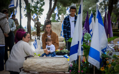 Bereaved families visit the graves of fallen soldier during Memorial Dayat Mount Herzl Military Cemetery in Jerusalem on May 13, 2024. (Chaim Goldberg/Flash90) Bereaved families visit the graves of fallen soldier during Memorial Dayat Mount Herzl Military Cemetery in Jerusalem on May 13, 2024. (Chaim Goldberg/Flash90)