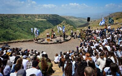 Illustrative: High school students, along with bereaved families and IDF soldiers, attend a memorial ceremony remembering fallen soldiers, overlooking ancient Gamla and the Sea of Galilee in the Golan Heights, on May 13, 2024. (Michael Giladi/Flash90)