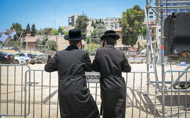 Haredi Jews watch preperations for the Lag B'Omer festivities at the Shimon HaTzadik tomb in Jerusalem on May 22, 2024. (Photo by Arie Leib Abrams/FLASH90) Haredi Jews watch preperations for the Lag B'Omer festivities at the Shimon HaTzadik tomb in Jerusalem on May 22, 2024. (Photo by Arie Leib Abrams/FLASH90)