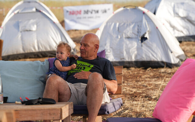 Residents of evacuated communities in northern Israel and supporters set up a tent city to demand the government return them to their homes, at Amiad Junction, in northern Israel, May 23, 2024. (Ayal Margolin/Flash90) Residents of evacuated communities in northern Israel and supporters set up a tent city to demand the government return them to their homes, at Amiad Junction, in northern Israel, May 23, 2024. (Ayal Margolin/Flash90)